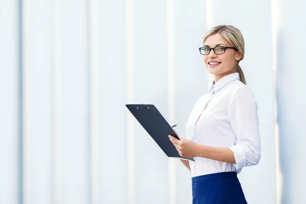 Cheerful business woman holding folder — Stock Photo, Image