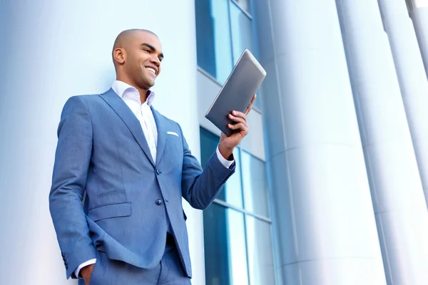 Upbeat businessman standing near column — Stock Photo, Image