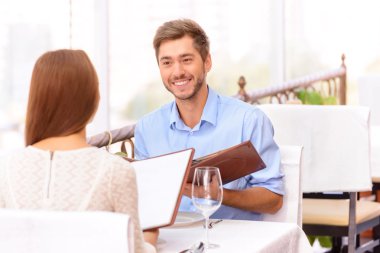 Loving couple looking through menu in the restaurant