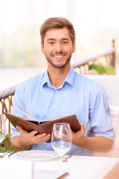 Loving couple looking through menu in the restaurant — Stock Photo, Image