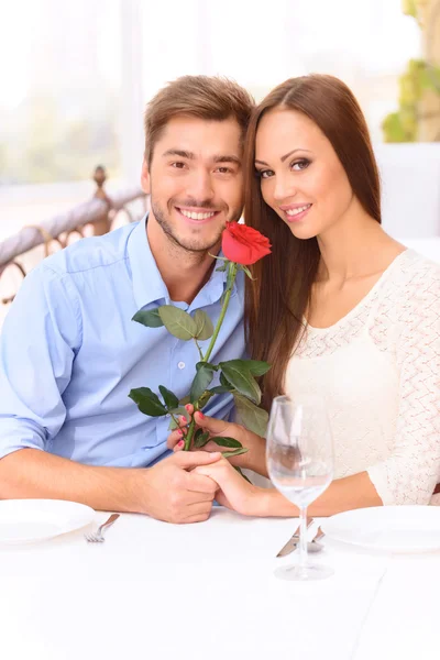 Nice couple sitting at the table — Stock Photo, Image