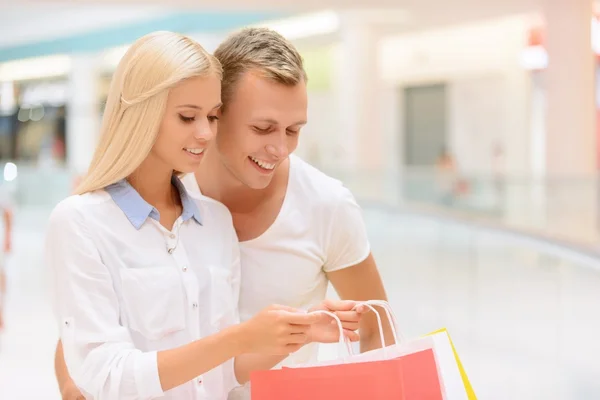 Upbeat couple doing shopping