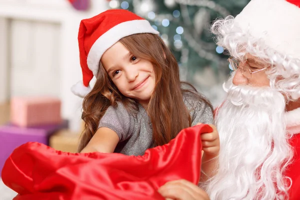 Pretty girl sitting with Santa Stock Picture