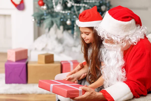 Mooi meisje zit met Santa — Stockfoto