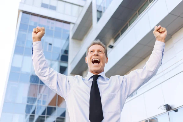 Nice businessman standing near office building — Stock Photo, Image