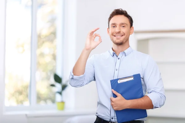 Nice realtor holding folder — Stock Photo, Image