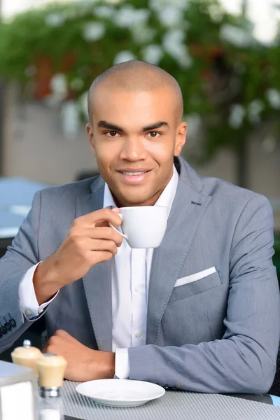 Pleasant businessman drinking coffee — Stock Photo, Image