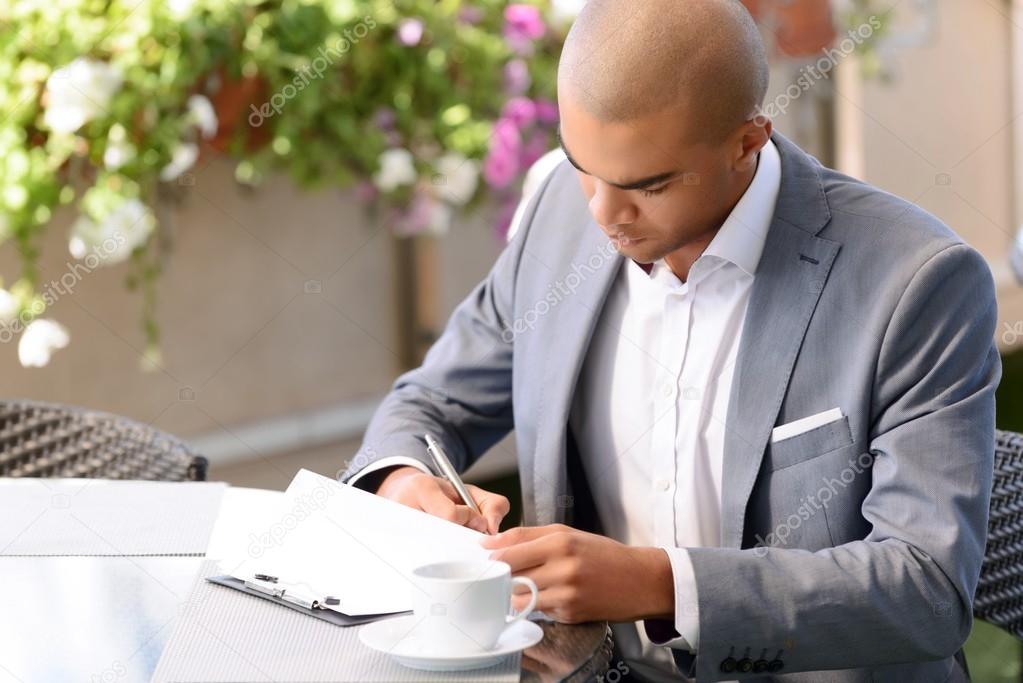 Handsome businessman making notes