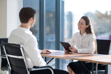 Yeni eleman. İK müdürü ofiste erkek bir adayla görüşüyor.