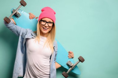 Cheerful girl standing on blue background
