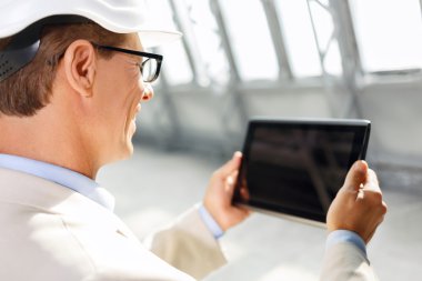 Pleasant architect holding laptop