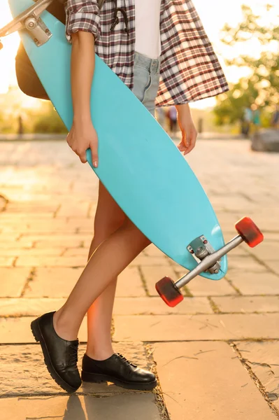 Overjoyed girl holding skateboard — 스톡 사진