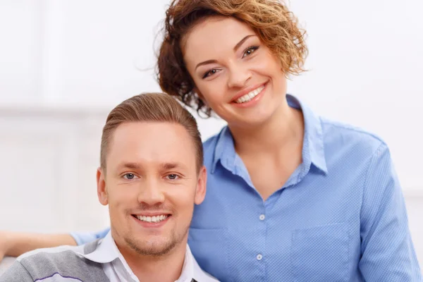 Pleasant couple sitting in the armchair — Stockfoto