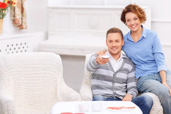 Pleasant couple sitting in the armchair — Stok fotoğraf