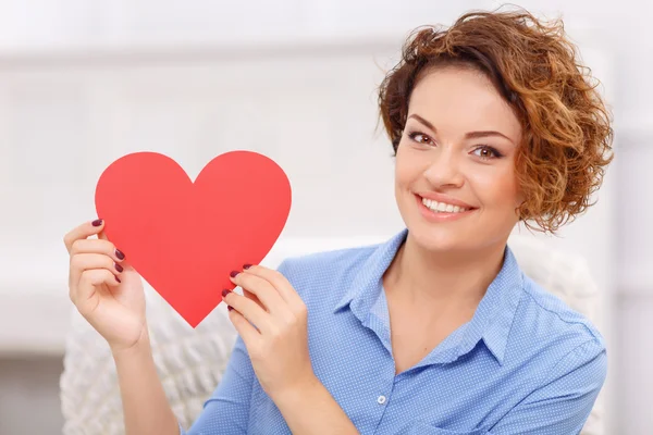 Cheerful girl holding heart — Stock Photo, Image