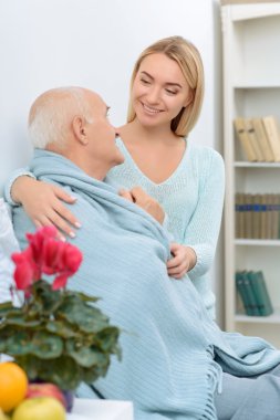Smiling granddaughter is happy to give care.