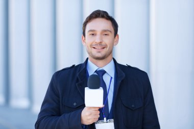 Smiling journalist is ready to record reportings.