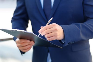 Clipboard and writing pen in usage.