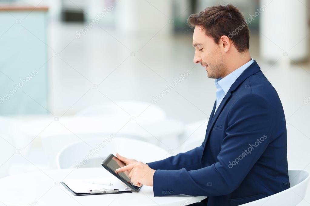 Young gentleman occupied with his tablet