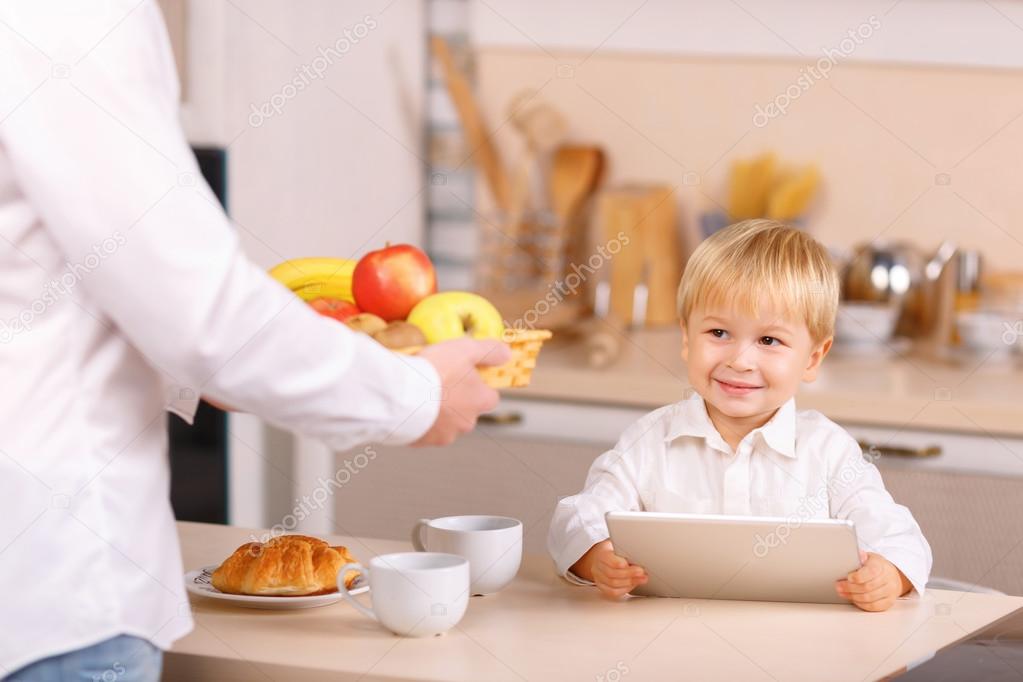 Dad offers his son to take any fruit.