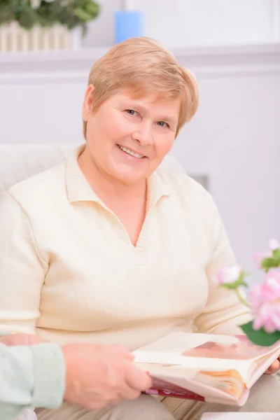 Pleasant couple looking through photo album — Stock Photo, Image