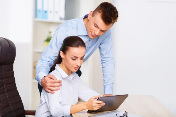 Office worker embraces his colleague from behind. — Stock Photo, Image