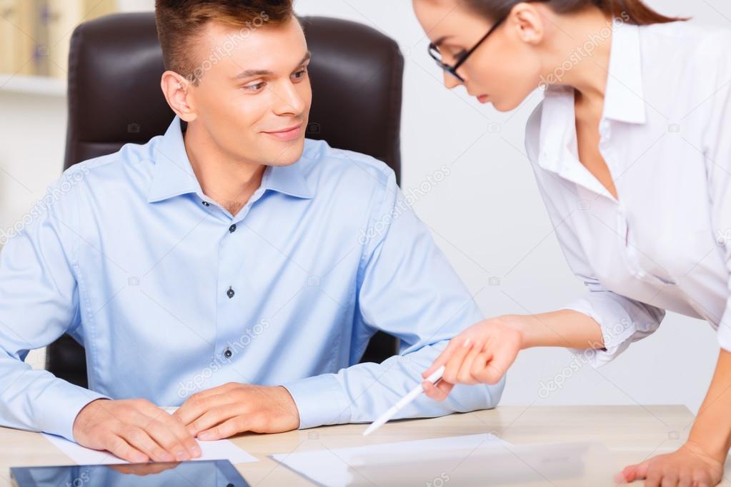 Officeman admires his assistants beauty instead of working.