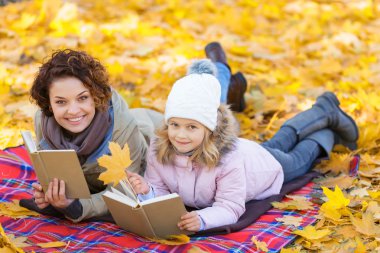 mother and daughter reading books