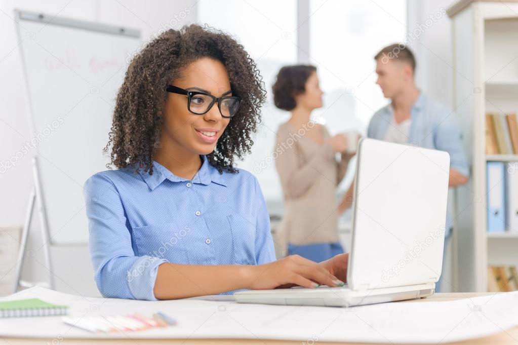 Female employee is working on the laptop.