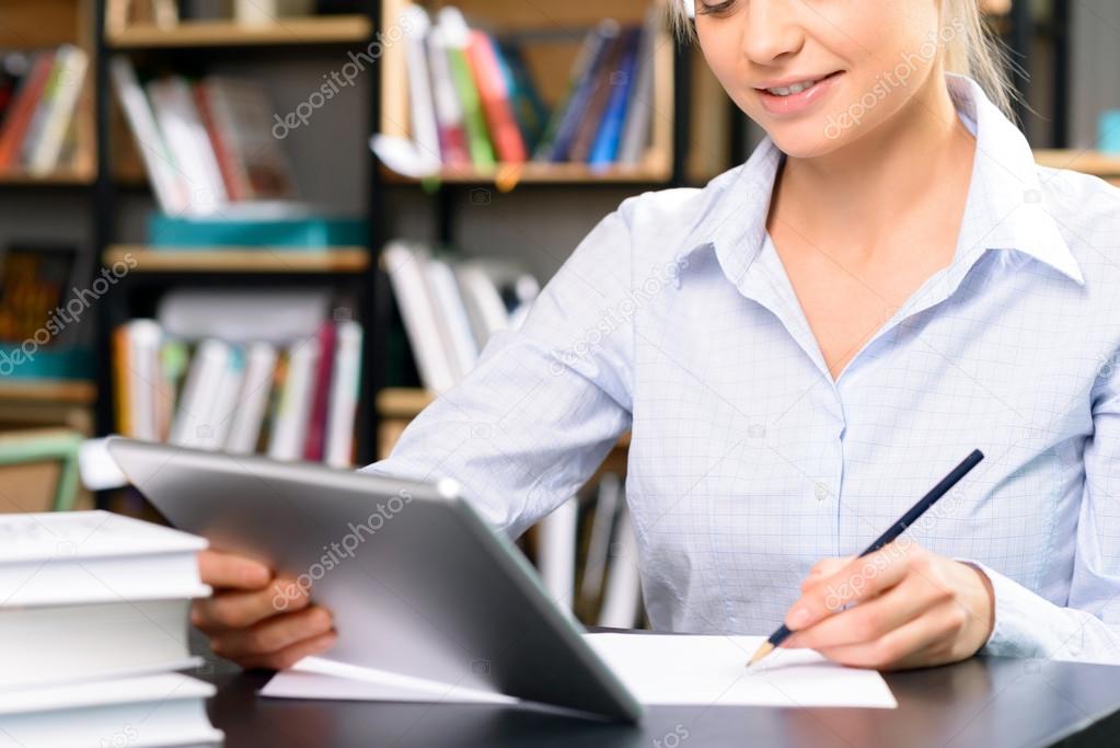 Young woman working in the library.