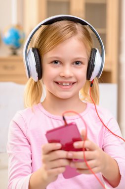 Vivacious little girl listening to music