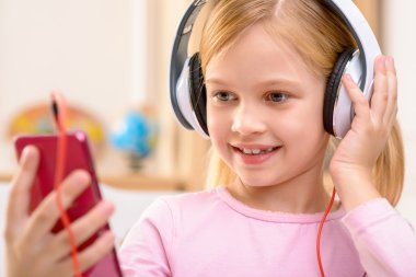 Vivacious little girl listening to music