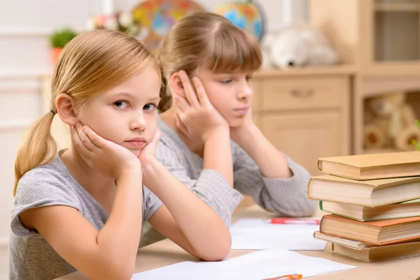 Pretty little girls sitting at the table — Stok fotoğraf