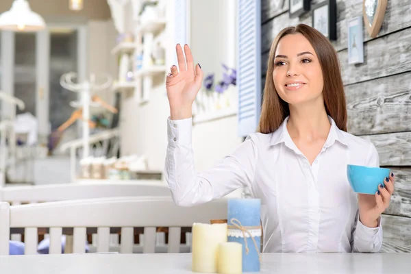 Woman holding hand up and calling the waiter — Stok fotoğraf