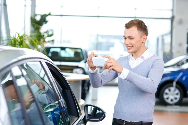 Pleasant man choosing car in auto show — Stock Photo, Image