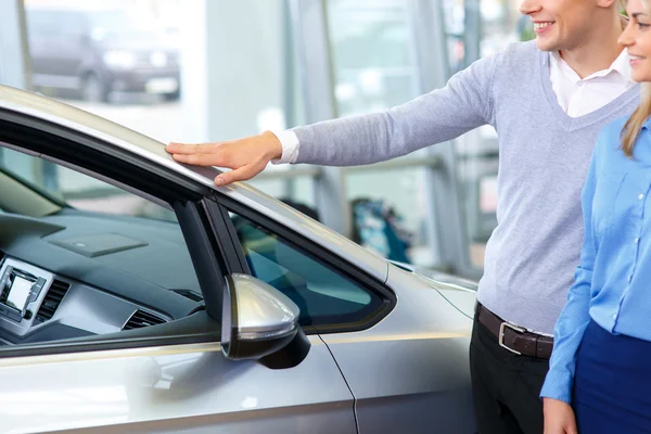 Pleasant man choosing car in auto show — Stock Photo, Image