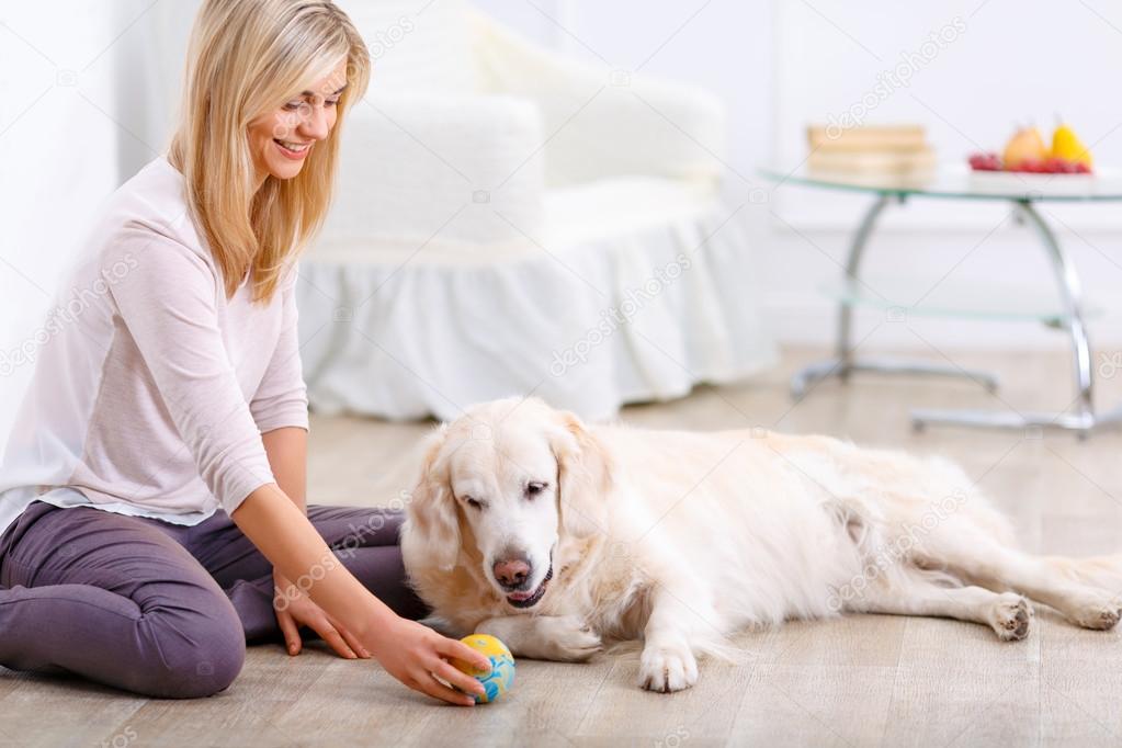 Pleasant woman having fun with a dog 