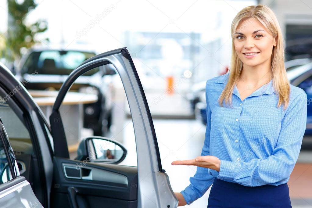 Sale assistant showing the car