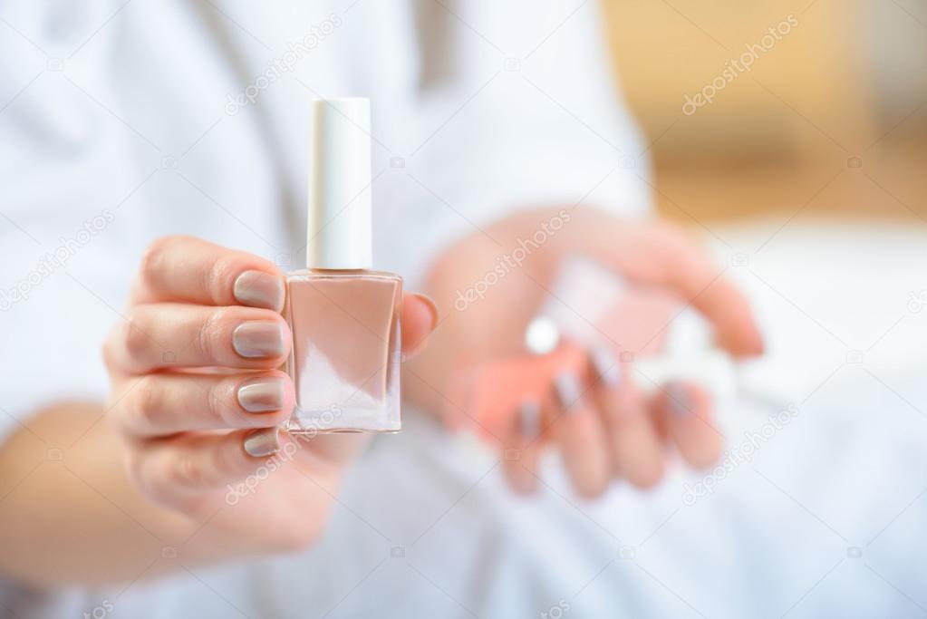 Young girl showing nail polish.