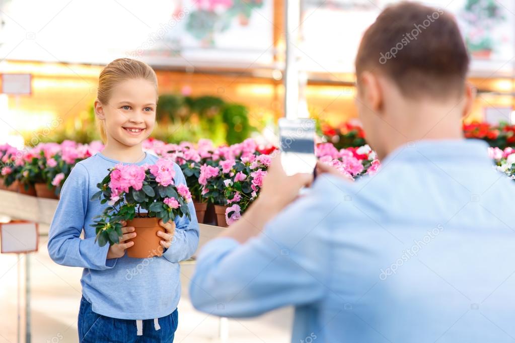 Little girl posing with flower.