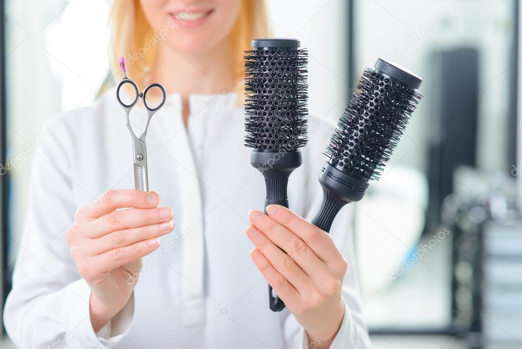 Professional stylist showing various tools.