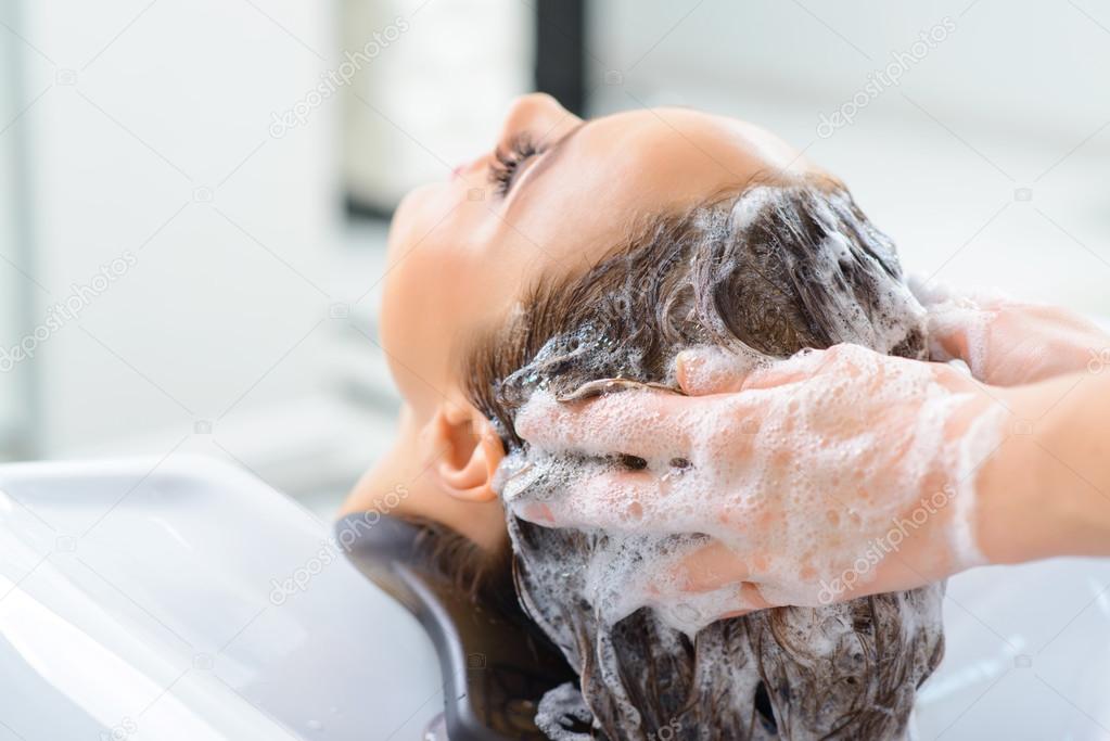 Stylist is washing clients hair.