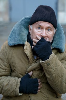 Homeless senior-aged man looks startled an alarmed. clipart