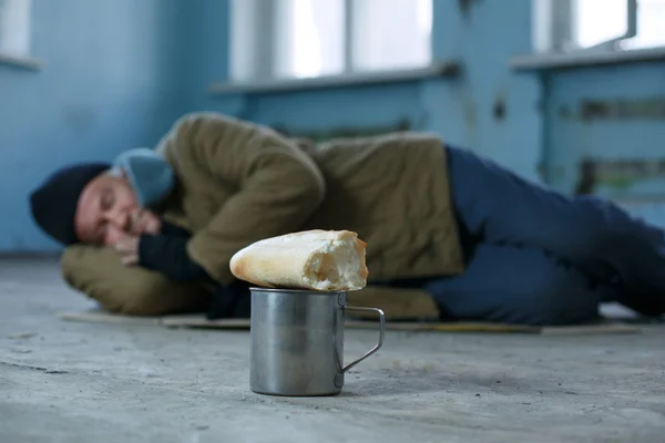 Hombre sin hogar durmiendo en el cartón . — Foto de Stock