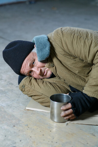 Homeless man lying on the floor.