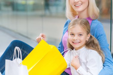 Cheerful mother and daughter having shopping