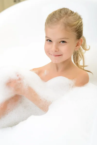 Pleasant little girl playing in bath tube — Stock Photo, Image