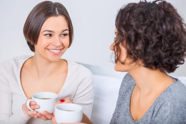 Two young sisters drinking tea. — Stock Photo, Image