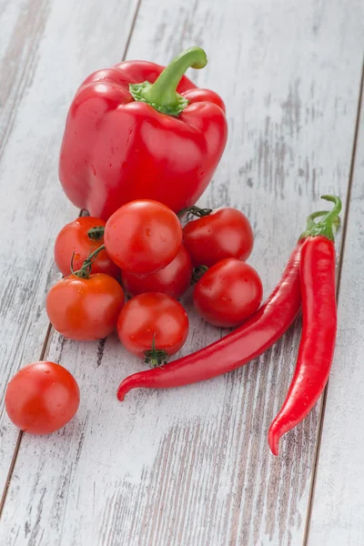 Pepper and tomatoes lying on the table — Stock Photo, Image