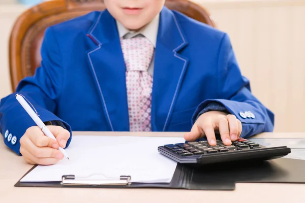 Little boy is busy accounting. — Stock Photo, Image